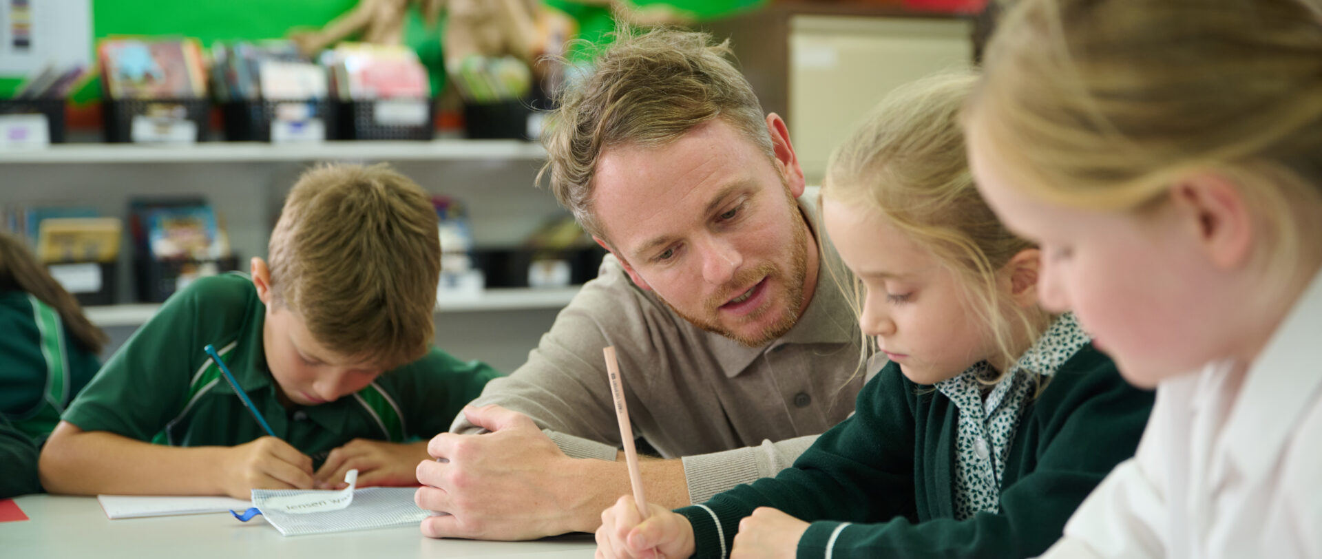 students working in class with their teacher